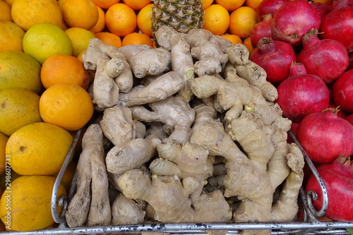 ginger roots and fruit at background, healthy food