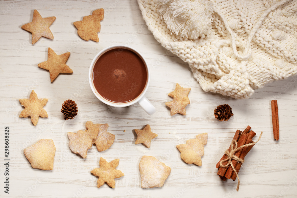 Hot chocolate in white cup with star shaped cookies
