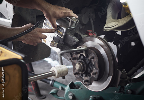 Disc brake system repair. Brake disc with grinding machine and vehicle brake-disc.