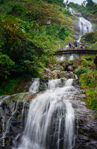 A group of tourism on a bridge at Silver Waterfall Sa Pa district Lao Cai province Vietnam photo