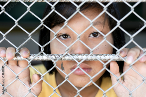teen girl hold cage with eye sad and hopeless, Human trafficking concept, human rights violations, Stop violence and abused children. traumatized children concept.