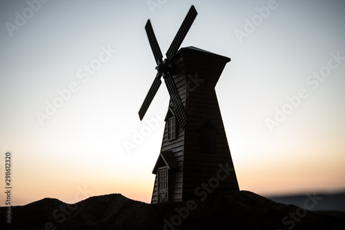 Sunset sky and old windmill standing on hill