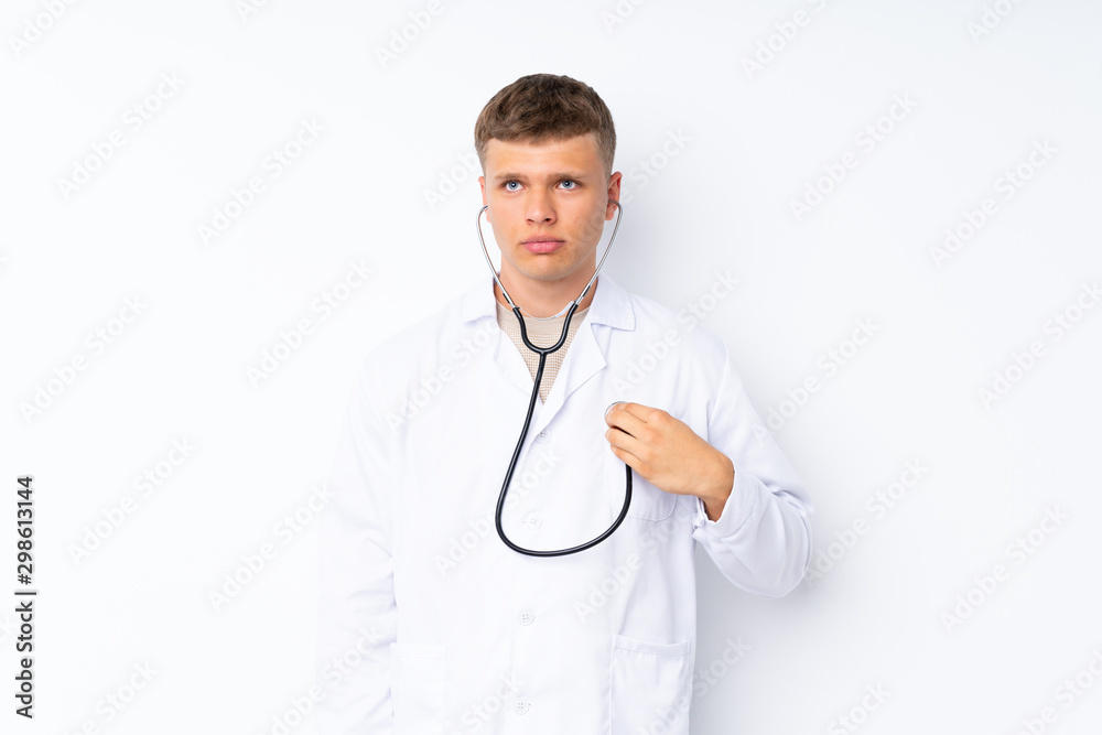 Young handsome man over isolated white background with doctor gown Young handsome man over isolated white background with doctor gown