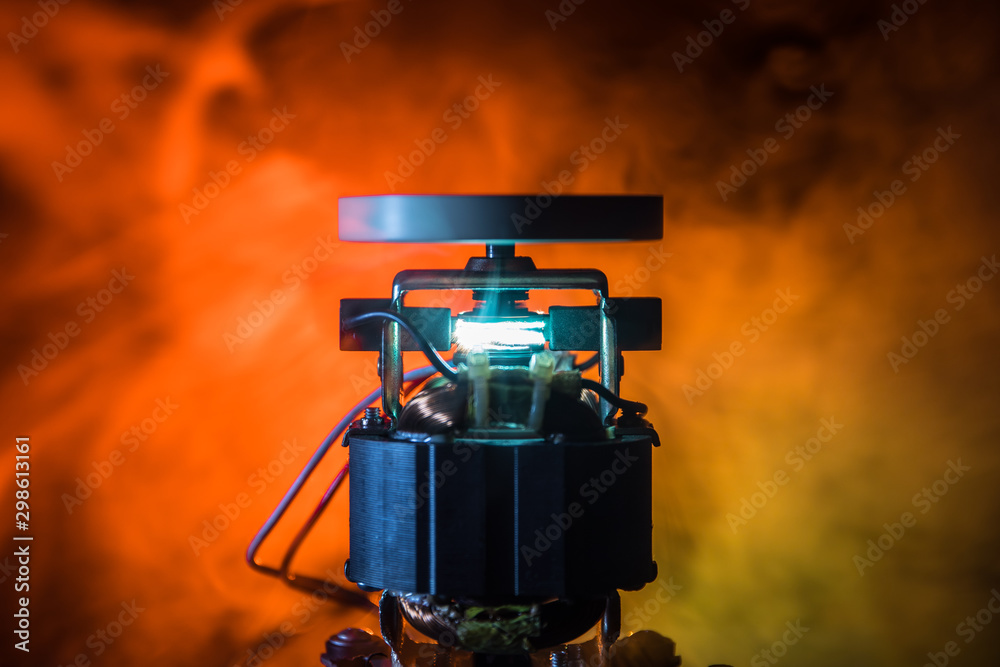 Industrial technology concept, Old electric motor spinning on dark orange  background. Broken motor burning and sparking. Stock-Foto | Adobe Stock