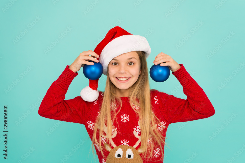 Festive mood. Decorative accessories. Decorating christmas tree. Girl smiling face hold balls blue background. Let kid decorate christmas tree. Add more decorations. Getting child involved decorating