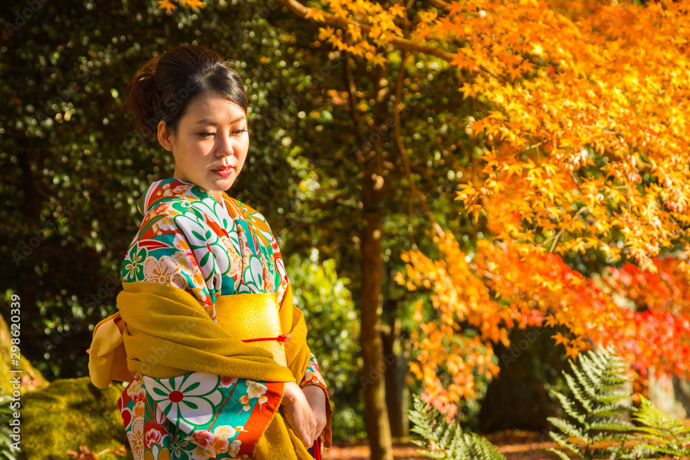 An Asian woman in traditional Japanese dress or Kimono during autumn season in Kyoto An Asian woman in traditional Japanese dress or Kimono during autumn season in Kyoto