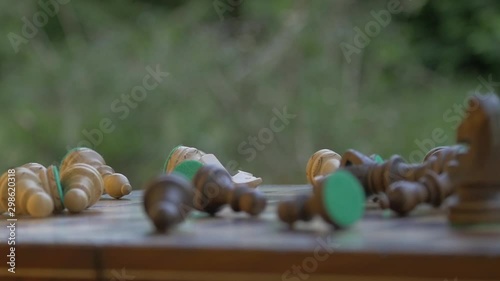 Slow motion Angry hitting the chessboard. Chess pieces are flying in the air. side view