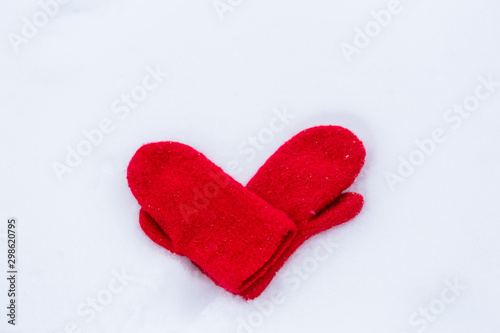 Heart shaped mittens on snow