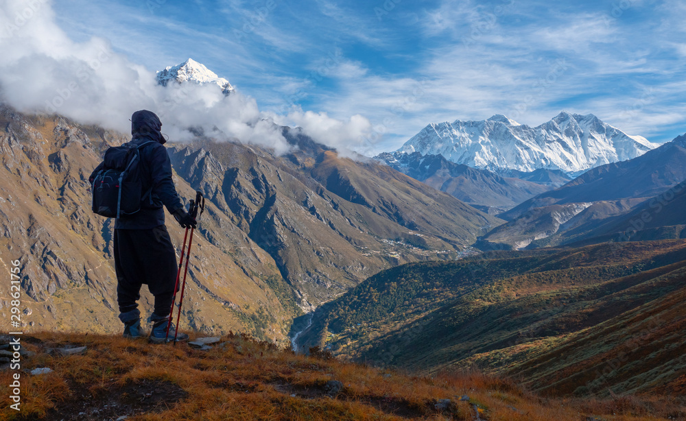 Active hiker hiking, enjoying the view  at Himalaya mountains and Mount Everest landscape. Travel sport lifestyle concept