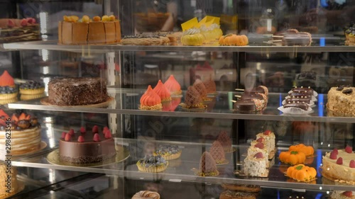 Glass counter with a variety of colorful pastries and desserts