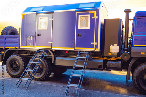 Mobile building for accommodation of workers. house on the truck. Truck with a mobile laboratory. Blue mobile home. Providing workers with a room for rest.