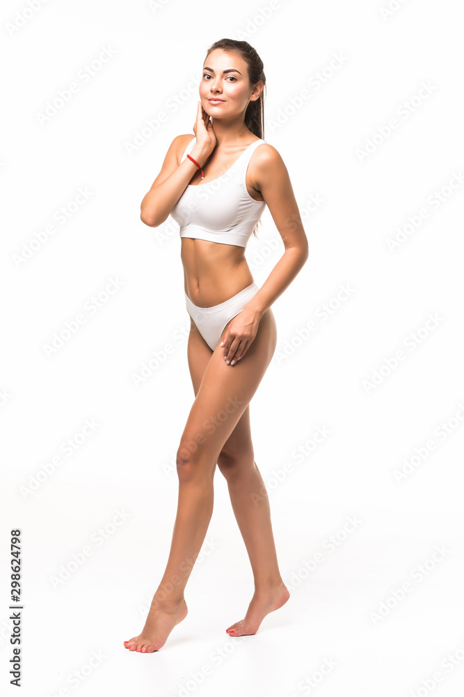 Muscular woman's body in white lingerie isolated on white background Muscular woman's body in white lingerie isolated on white background