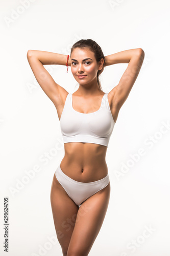 Muscular woman's body in white lingerie isolated on white background