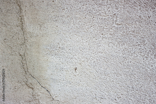 White concrete wall with cracks.