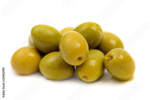 Pile of wet green olives macro isolated