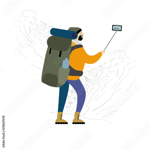 Hiker with backpack takes selfie in mountains.