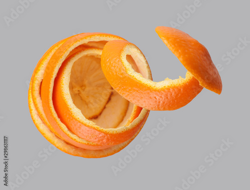 peel of an orange spiral, peeled orange, top view, on a gray background