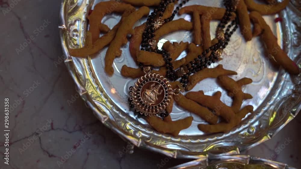 Jewellery placed on top of haldi sticks Jewellery placed on top of haldi sticks