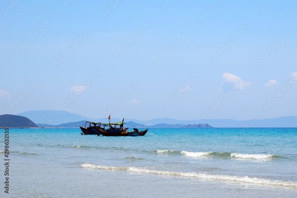 Vietnamese boat is on the sea. Beautiful tourist background.