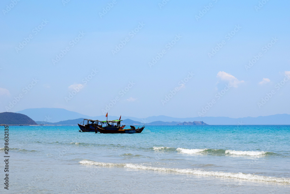 Vietnamese boat is on the sea. Beautiful tourist background. Vietnamese boat is on the sea. Beautiful tourist background.