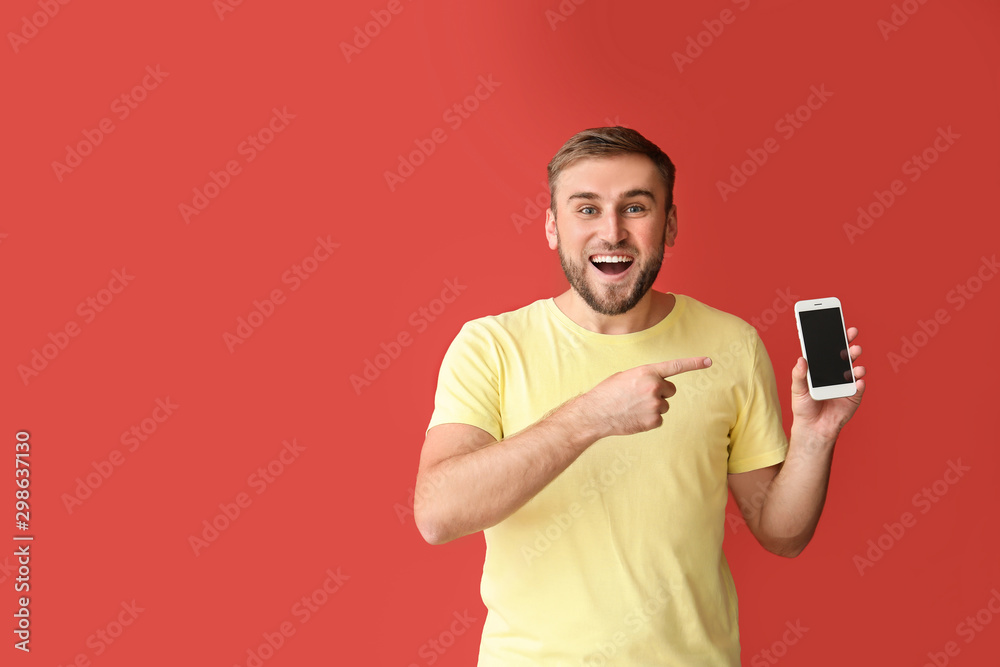Happy young man with mobile phone on color background Happy young man with mobile phone on color background