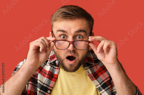 Surprised young man on colo...