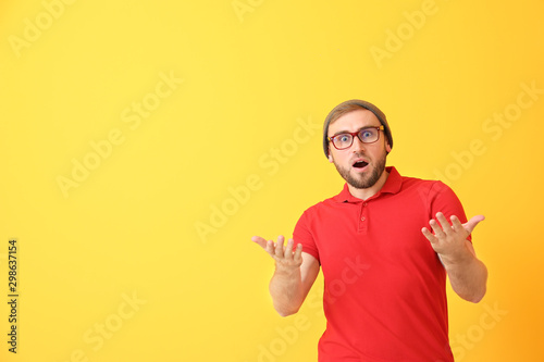 Shocked young man on color ...