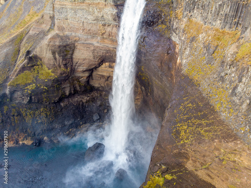 Dramatic overview of Haifoss waterfall, the fourth highest waterfall(122m) of the island, and colorful canyon situated near the volcano Hekla in southern Iceland.. photo