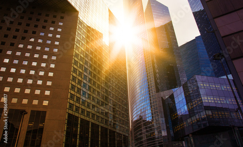 Foto Skyscraper glass facades on a bright sunny day with sunbeams in the blue sky