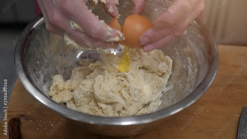 The process of manually baking dough. Women's hands are cooking