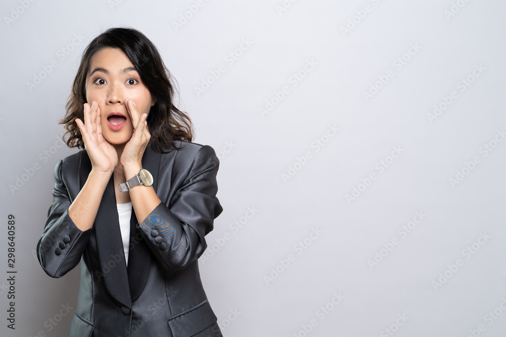 Woman make whisper gesture isolated over white background Woman make whisper gesture isolated over white background