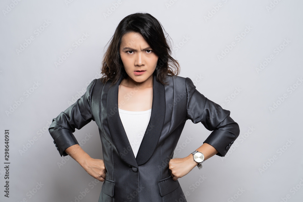 Angry woman standing isolated over white background Angry woman standing isolated over white background