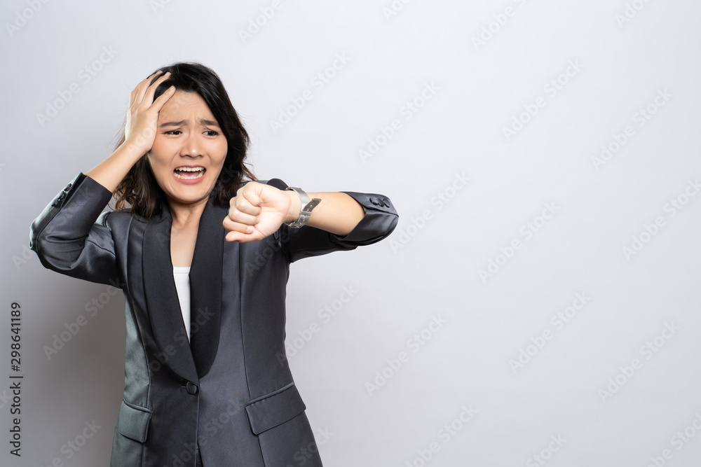 Shocked woman holding hand with wrist watch isolated on a white background Shocked woman holding hand with wrist watch isolated on a white background