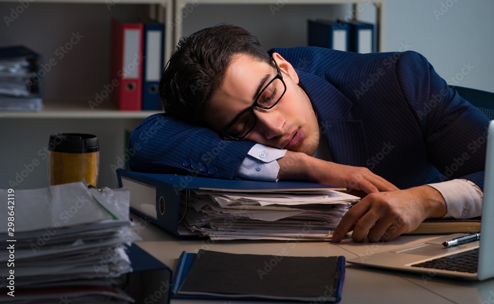 The businessman tired and sleeping in the office after overtime The businessman tired and sleeping in the office after overtime