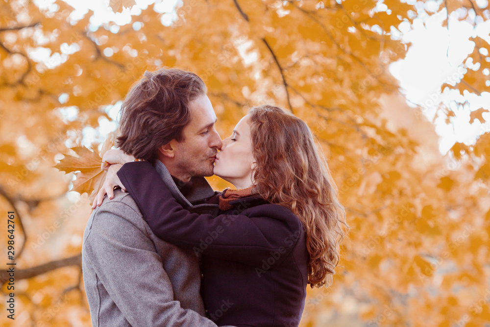 Couple kissing in autumn park Couple kissing in autumn park