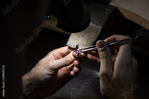master of jewelry manually inserts gems into the frame of future jewelry