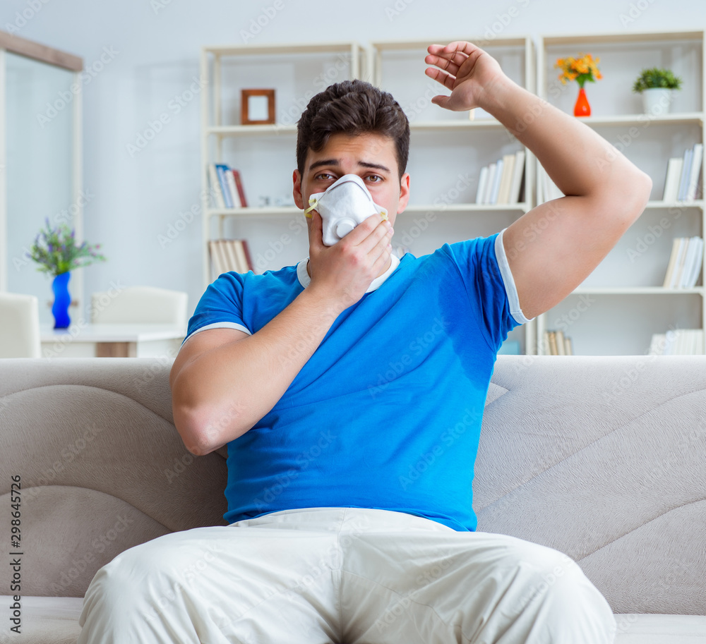 Man sweating excessively smelling bad at home Man sweating excessively smelling bad at home