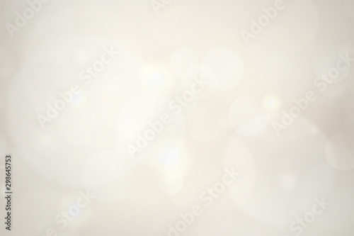 abstract blur white bokeh circles on golden background.