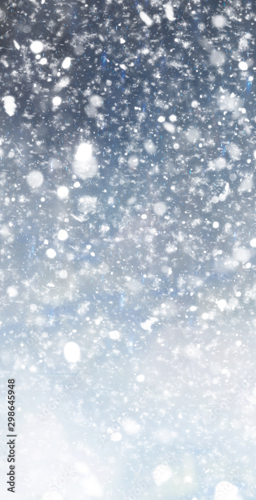 Abstract winter christmas background with shiny snow and blizzard. Space for text. Vertical for stories