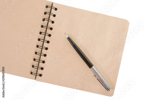 Open blank square notebook of brown kraft paper with a spiral and ballpoint pen lie on a white background, top view