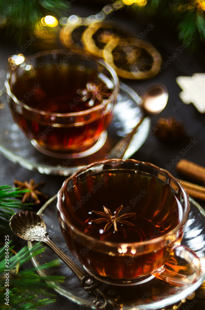 Couple cups of hot spicy tea with anise and cinnamon, selective focus Couple cups of hot spicy tea with anise and cinnamon, selective focus
