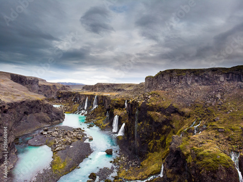 Scenic landscape view of incredible Sigoldugljufur canyon in highlands with turquoise river  Iceland. Volcanic landscape on background. Popular tourist attraction..