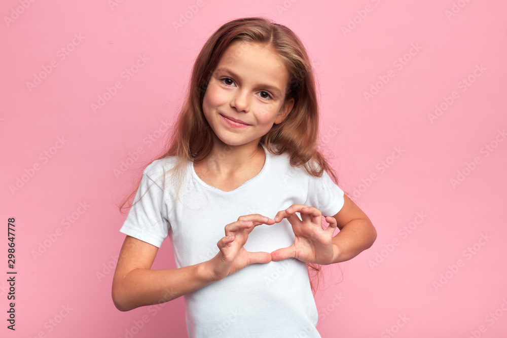 Portrait of young smiling beautiful blonde girl making heart with palms. close up portrait, isolated pink background, body language. reaction, love, positive feeling and emotion - obrazy, fototapety, plakaty 