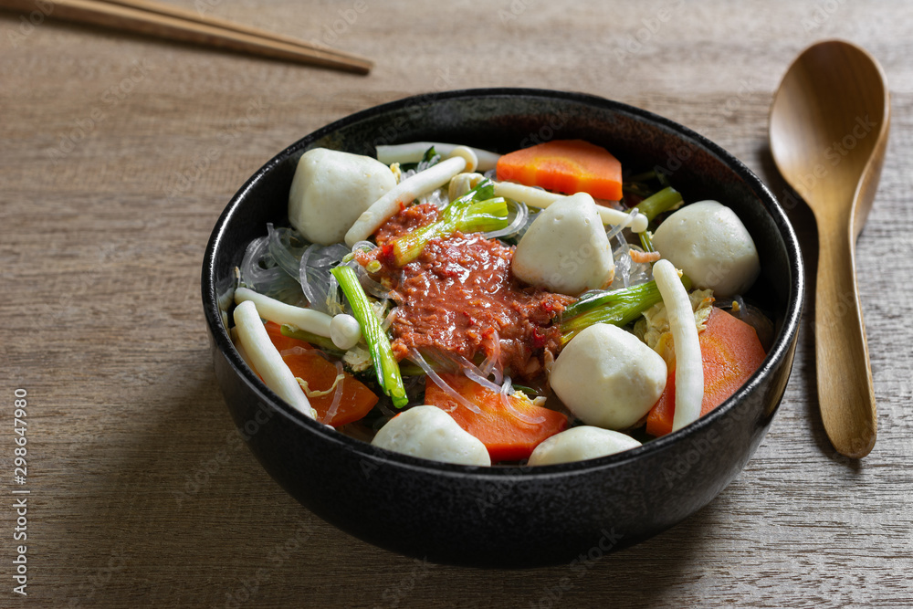 close up of fish ball sukiyaki in a ceramic bowl on wooden table. asian homemade style food concept. close up of fish ball sukiyaki in a ceramic bowl on wooden table. asian homemade style food concept.