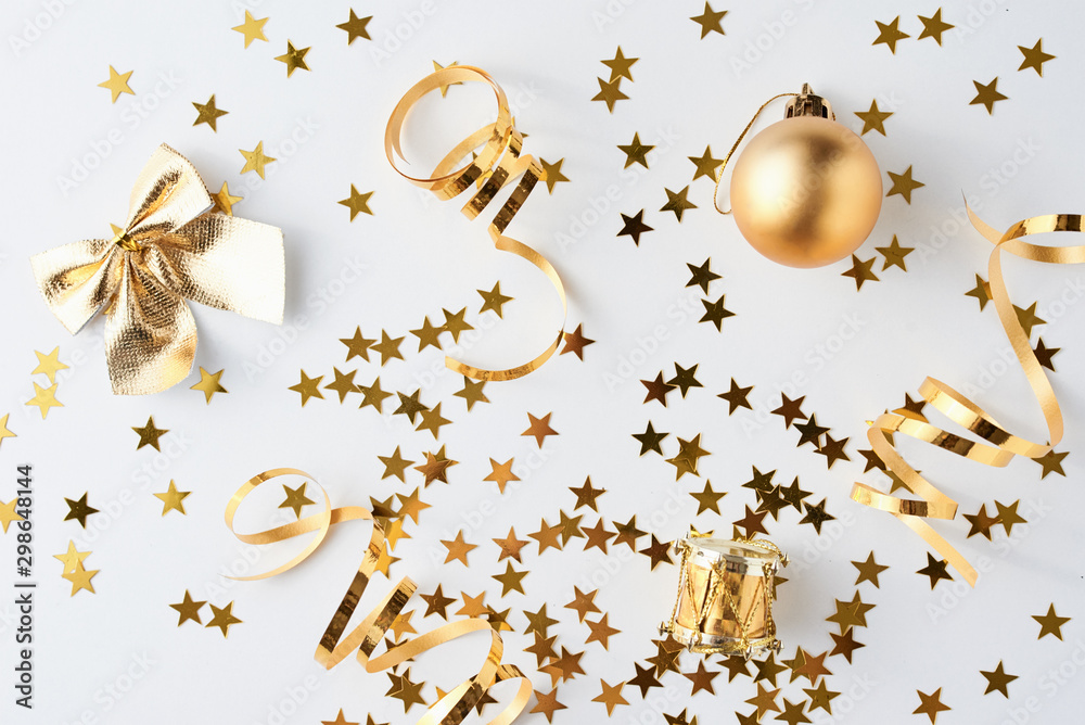 Fototapeta premium Golden glitter confetti and decorations on a white background