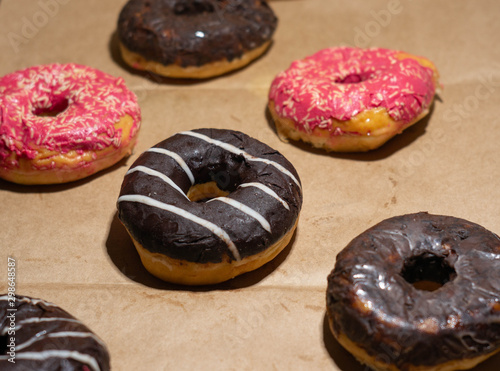 Creative layout of tasty delicious doughnuts on eco paper background photo