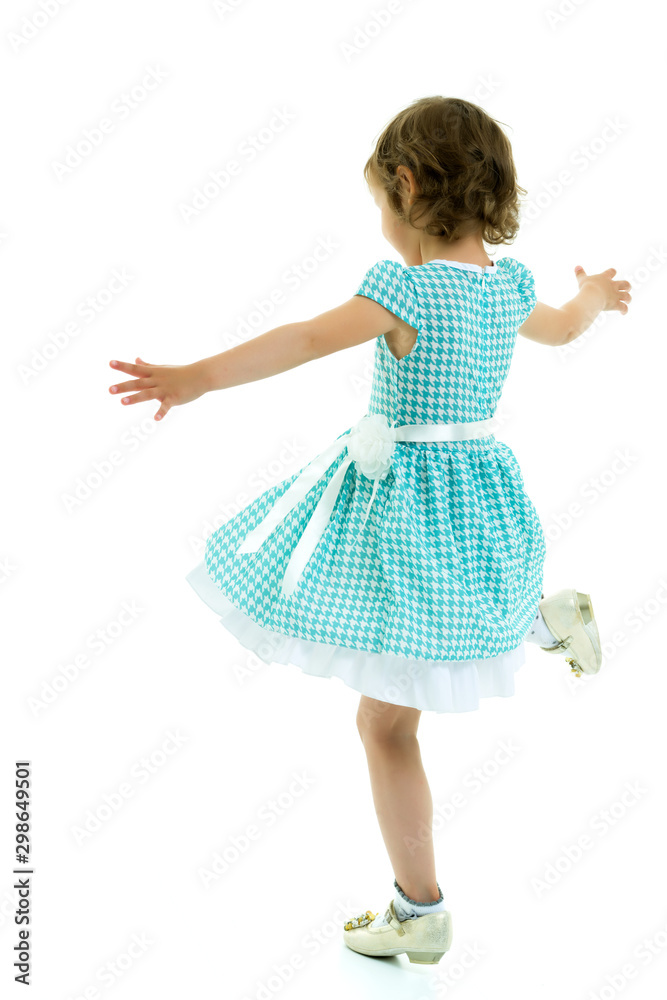 A cheerful little girl is dancing. A cheerful little girl is dancing.