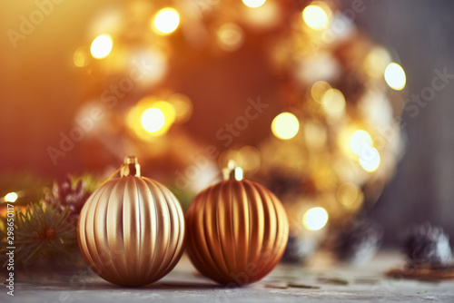 Schilderij op canvas Christmas decorations with golden balls, fir tree branch and garland lights on a