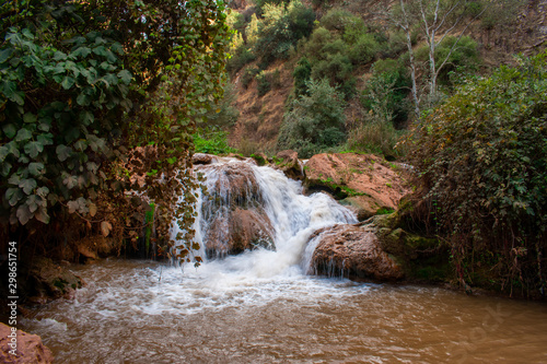 Small waterfall on river in Atlas Mountains  Morocco. Water stream in Forest. 