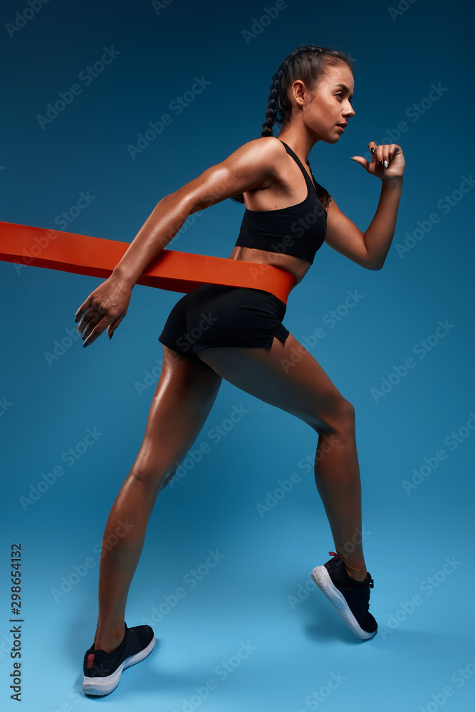 pleasant awesome girl goes in for sport, full length side view photo. motivation concept, strength training